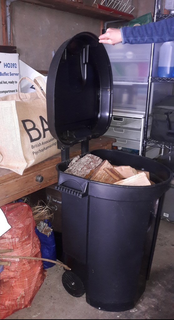 logs stored in a plastic rubbish bin