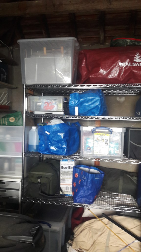 Picture of shelves made of metal racks with storage bags and boxes.